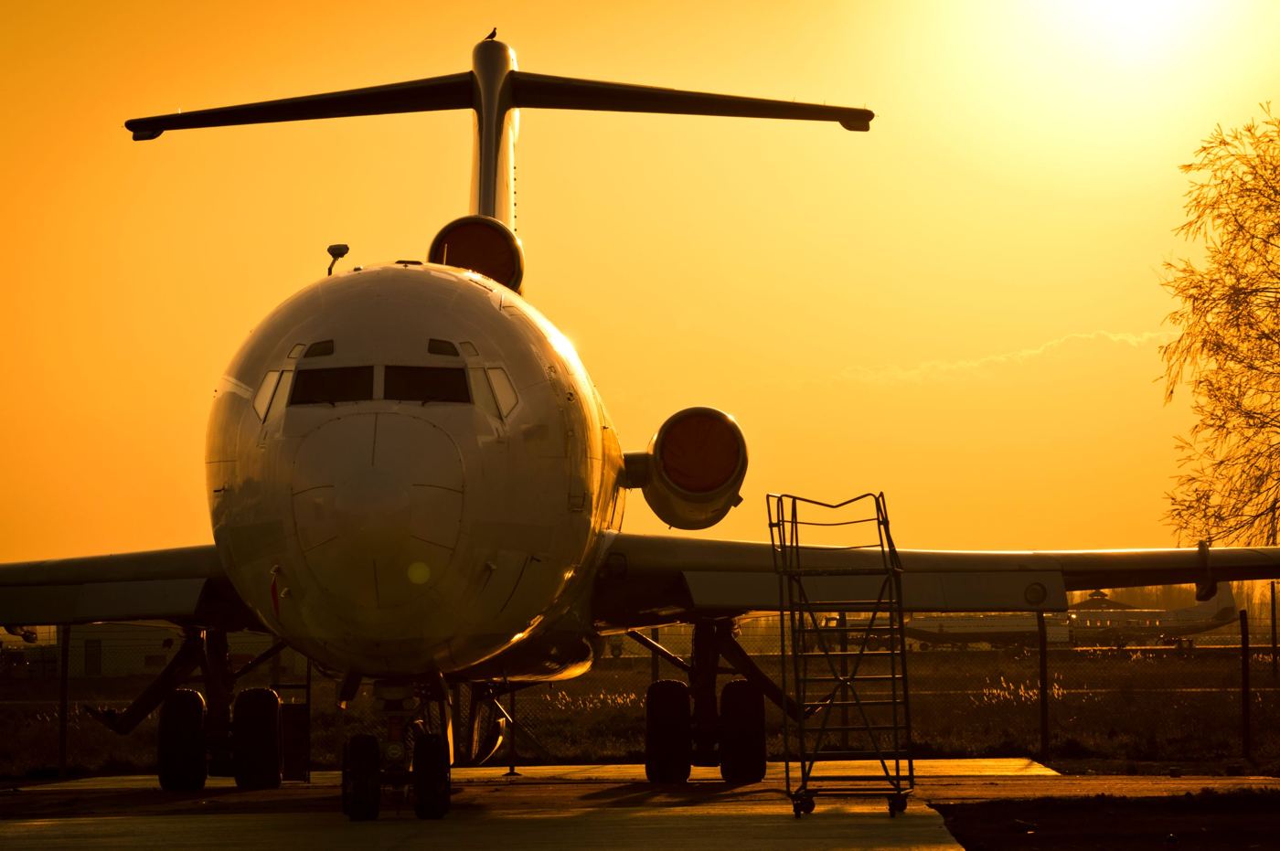 An aircraft on stand at sunset